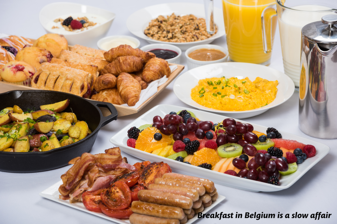 Belgian breakfast spread with fruit, pastries and meat 